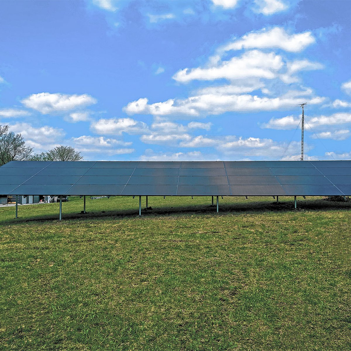 Ground-mounted solar panel system installed by Shinnova on a sunny day