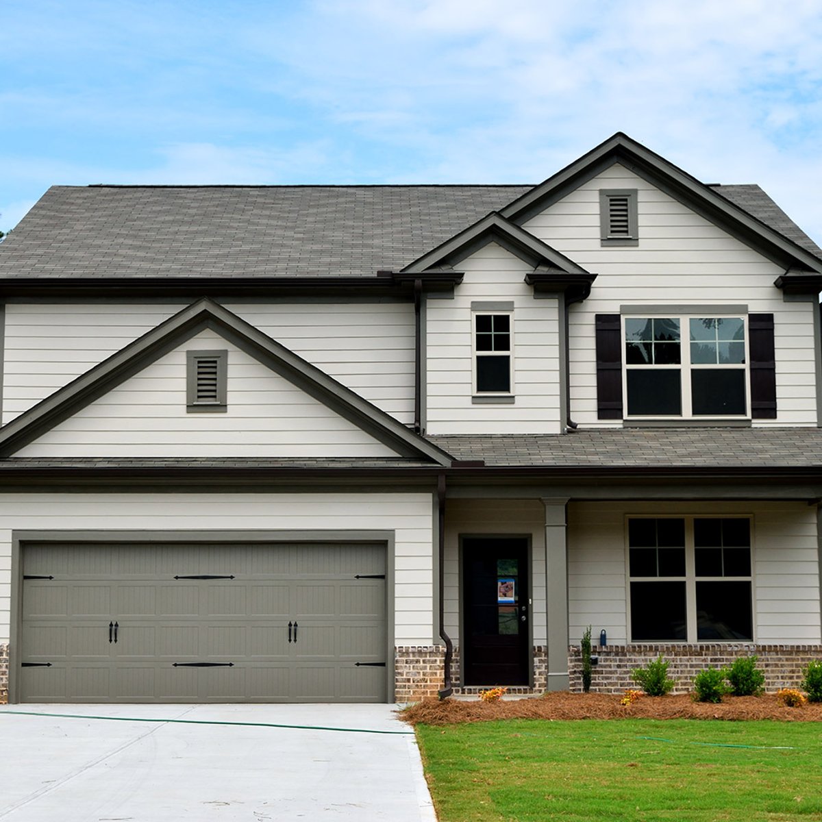 Two-story house with new siding installed by Shinnova's siding experts.