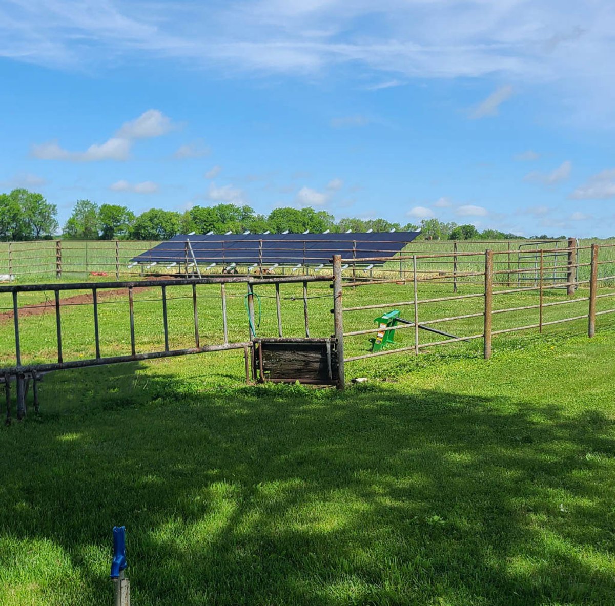 Rural ground-mounted solar panels installed in a fenced field by Shinnova