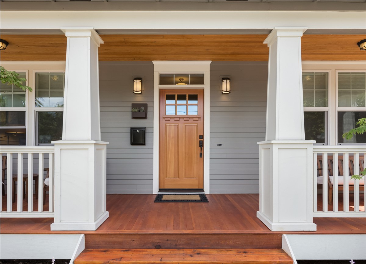 Modern front porch with wooden door and white columns