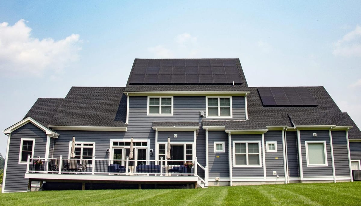 Shinnova-installed solar panels on a modern two-story home with a large backyard